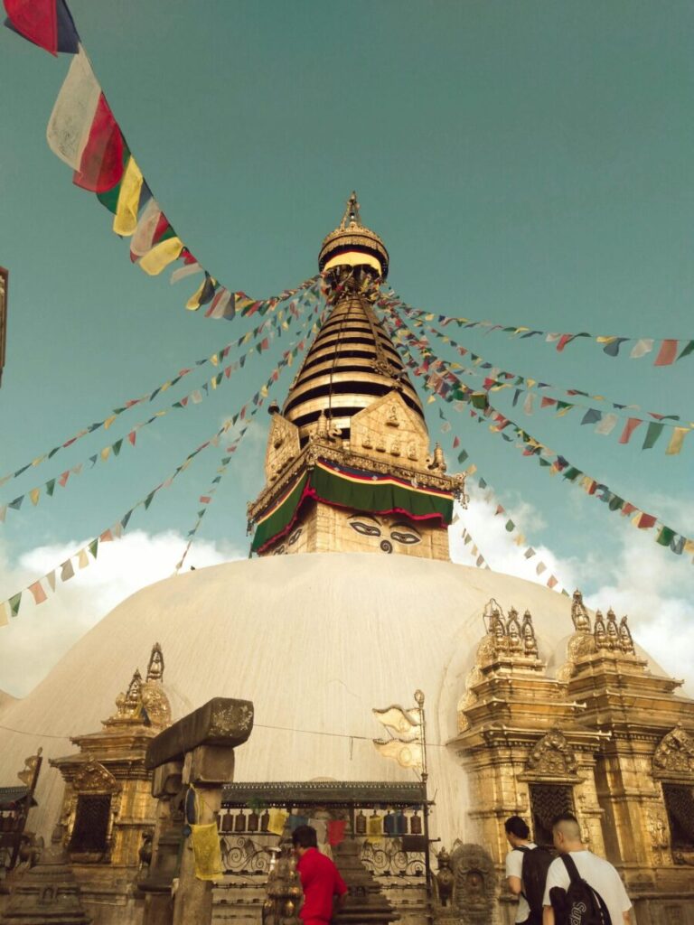 Majestic view of Swayambhunath Stupa with prayer flags in Kathmandu, Nepal.